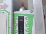 a close up of a machine with a green and white design
