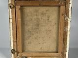 an old picture frame with a piece of wood in it on a white surface