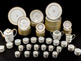 many cups and saucers that are sitting on a table