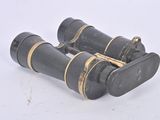 two black binoculars sitting on a white surface