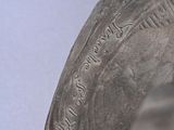 a close up of a silver object on a table