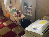 an image of a cluttered room with a desk and a printer