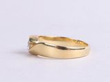 an image of a gold ring on a white surface