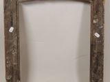 an old wooden picture frame with a tag on it