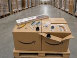 an amazon box with a smile on it sitting on a pallet