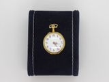 a small pocket watch with a key on it
