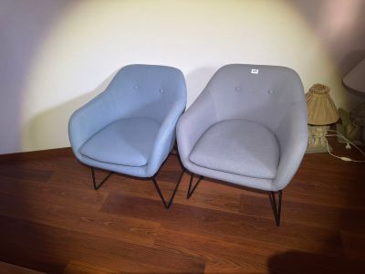 two chairs sitting next to each other on a wooden floor