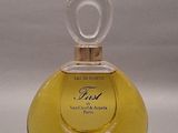 yellow perfume bottle with a clear top on a white surface