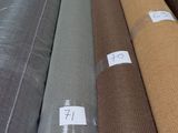 a lot of different colors of fabric on the floor