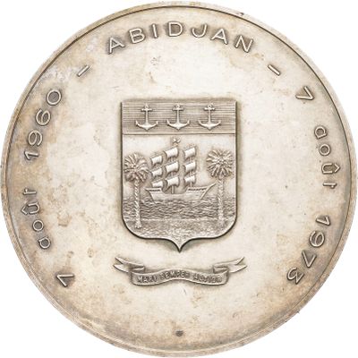 an old silver coin with a coat of arms and a ship on it