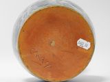 a close up of a vase with a tag on it