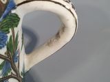 a blue and white coffee cup with a bird on it