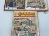 three comics are on display on a table in a store