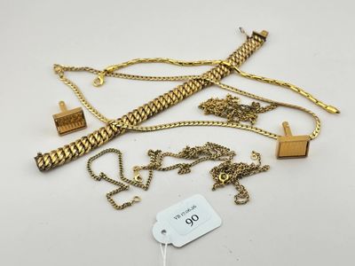 une collection de colliers et de bracelets en or posés sur un fond blanc