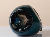 a blue vase sitting on top of a white table
