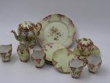a group of porcelain dishes and cups on a table