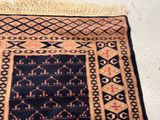 a black and orange rug with a pattern on it