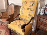 un fauteuil jaune placé devant une cheminée dans un salon