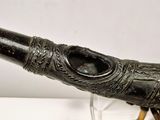a black pipe that is on display on a table