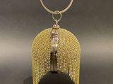 a gold purse with a chain hanging from it ' s side