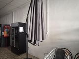 tables and chairs in a room with an umbrella on the wall