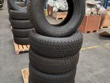 tires stacked on pallets in a warehouse with pallets in the background