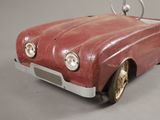 a red toy car that is sitting on a table