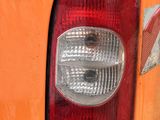 a close up of the tail light of an orange car