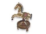 a wooden carousel horse on a stand on a white background