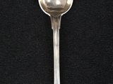 a spoon that is sitting on a black surface