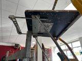 a metal shelf that has some tools on it