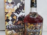 the bottle of henessy is next to the box