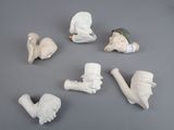 a group of clay figurines of different shapes and sizes
