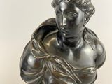 an antique bronze bust of a woman on a marble base