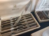 a lot of silverware in a box on a table