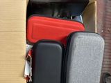 four pieces of luggage in a cardboard box on the ground