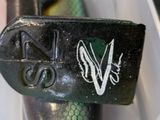 a close up picture of a parking meter with a sticker on it