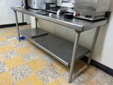 a stainless steel table with a coffee maker on top of it