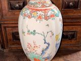 a large vase sitting on top of a wooden table