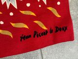 a red bag with a picture of a flower on it