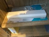 a wii remote sitting on top of a wooden shelf