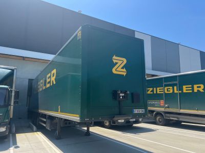 deux camions garés devant un immeuble