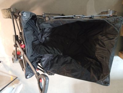 a black bag sitting on top of a black stroller
