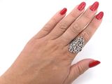 a woman ' s hand with red nails and a ring on it