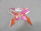 an orange and white bow with a pink and white design on it