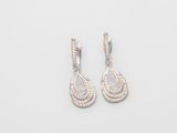 a pair of diamond earrings on a white background