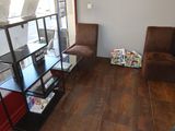 a room with a book shelf and a chair in it