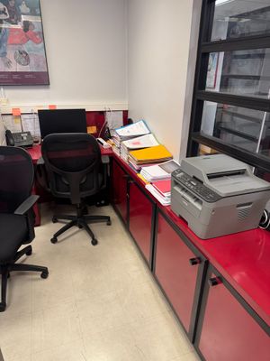 a red desk with a printer and a printer on it