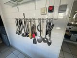 many utensils hanging on the wall in the kitchen