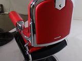 an image of a red and chrome barber chair